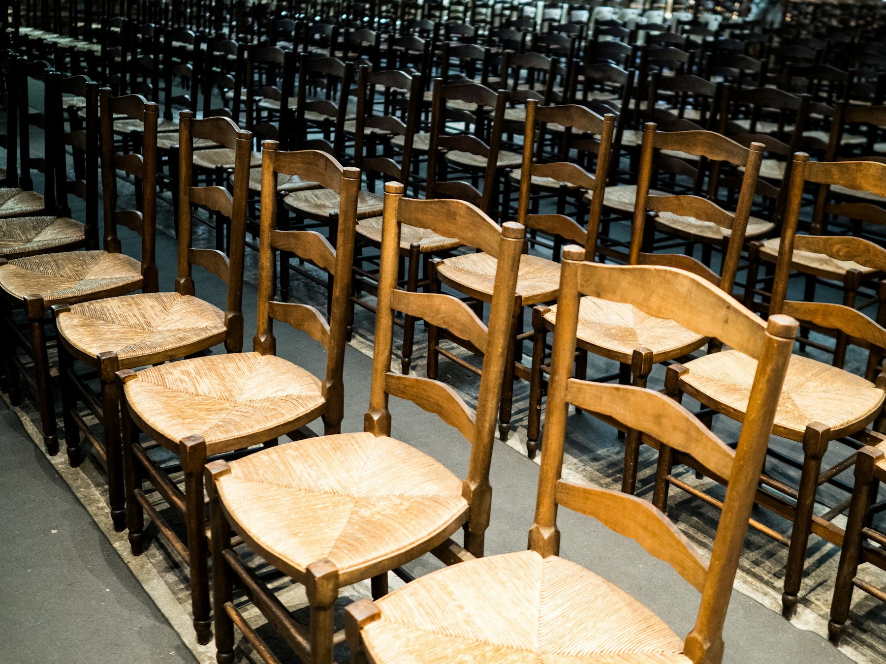 Wooden chairs set out in rows